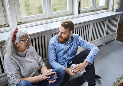 Senior mother talking with adult son.