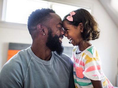 Man and daughter smiling with happiness