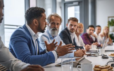 Black man speaking at a work meeting