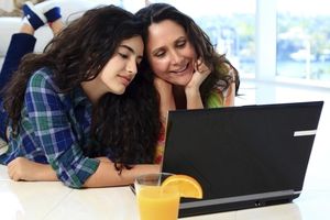 Mother and daughter looking at computer