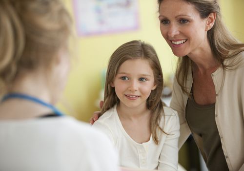 Mother and daughter with doctor in doctor's office