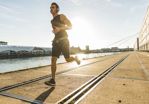 Young man jogging in the city at the river