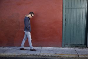 A young man in sunglasses takes a walk