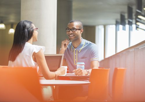 man and woman talking and smiling