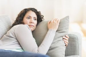 worried woman on sofa