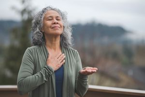 Hawaiian woman doing yoga pose outside