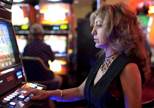 Woman using slot machine