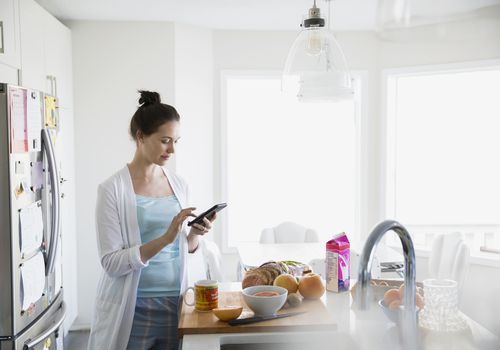 woman on phone in kitchen