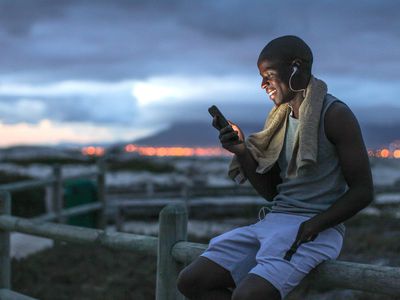 man smiling looking at his phone