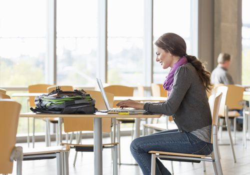 Student typing on a laptop