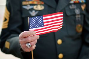 Veteran holding small American flag